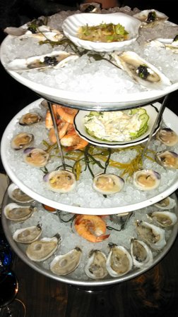 The Ordinary signature dishes Shellfish Towers, Smoked Oysters, Crispy Oyster Sliders, Porgy Schnitzel